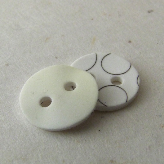 Shrink plastic buttons